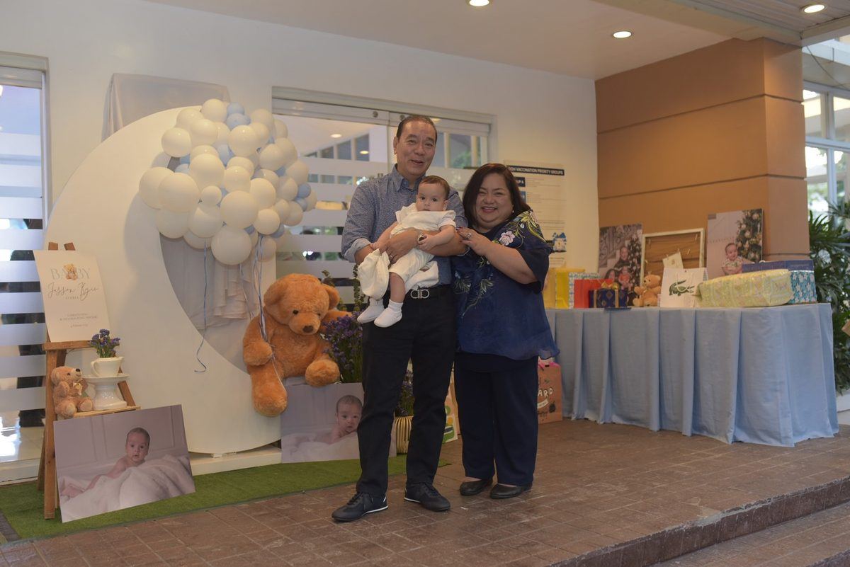 Averia family from the Philippines holding Baby Jesson at his christening — Novaparent surrogacy testimonial
